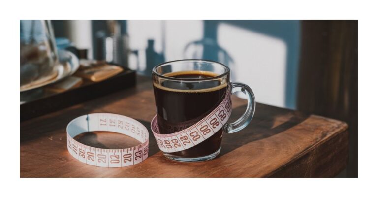 A cup of black coffee on a table with a measuring tape around it, representing weight loss with coffee.